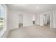 Bedroom with neutral colored walls and carpet, and a view into the house at 58 W Emily Gardens Dr, Selma, NC 27576