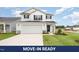 Charming two-story home featuring a two-car garage, well-maintained lawn, and classic black-and-white color scheme at 58 W Emily Gardens Dr, Selma, NC 27576