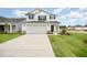 Charming two-story home featuring a two-car garage, well-maintained lawn, and classic black-and-white color scheme at 58 W Emily Gardens Dr, Selma, NC 27576