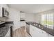 Bright kitchen features stainless steel appliances, granite countertops, and wood-look flooring at 58 W Emily Gardens Dr, Selma, NC 27576
