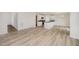 Open-concept living room and kitchen with hard surface floors, white cabinets, island, and stainless-steel appliances at 58 W Emily Gardens Dr, Selma, NC 27576