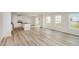 Open-concept living room and kitchen with hard surface floors, white cabinets, island, and stainless-steel appliances at 58 W Emily Gardens Dr, Selma, NC 27576