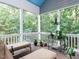 Screened porch area with overhead fan and wooded backyard views, ideal for outdoor relaxation at 604 Doddington Dr, Rolesville, NC 27571