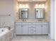 This bathroom has dual sinks, granite countertops, and modern light fixtures at 604 Doddington Dr, Rolesville, NC 27571