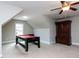 Spacious bonus room features a pool table, large armoire, neutral walls and carpet at 604 Doddington Dr, Rolesville, NC 27571