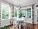 Eat-in breakfast area featuring large windows providing backyard views and hardwood floors at 604 Doddington Dr, Rolesville, NC 27571