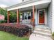 Inviting front porch featuring classic rocking chairs and decorative flower baskets at 604 Doddington Dr, Rolesville, NC 27571