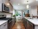 Bright kitchen with granite countertops, stainless appliances and a view into the eat-in breakfast area at 604 Doddington Dr, Rolesville, NC 27571