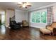 Large living room featuring hardwood floors, ample seating, and expansive windows with scenic views at 604 Doddington Dr, Rolesville, NC 27571