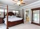 Spacious main bedroom with a four-poster bed, tray ceiling and ensuite bath at 604 Doddington Dr, Rolesville, NC 27571