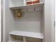 Bright mudroom with white shelving, hat rack, and ample storage space for an organized entryway at 604 Doddington Dr, Rolesville, NC 27571