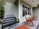 Inviting front porch with rocking chairs and swing perfect for relaxing outdoors at 604 Doddington Dr, Rolesville, NC 27571