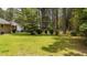 Large, green backyard with mature trees providing ample shade and privacy around the property at 625 Powell Dr, Rocky Mount, NC 27803