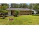 Expansive backyard featuring a lush lawn, mature trees, and the brick exterior wall of the home at 625 Powell Dr, Rocky Mount, NC 27803