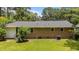 Expansive backyard featuring a lush lawn, mature trees, and the brick exterior wall of the home at 625 Powell Dr, Rocky Mount, NC 27803