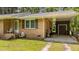 Exterior brick wall with a covered carport area featuring outdoor storage and a well-kept grassy space at 625 Powell Dr, Rocky Mount, NC 27803