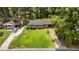 Bird's-eye view of a brick home featuring a front lawn, driveway, and lush trees around the property at 625 Powell Dr, Rocky Mount, NC 27803