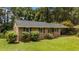 Well-maintained single story brick home with an adjacent covered carport and a mature, landscaped front yard at 625 Powell Dr, Rocky Mount, NC 27803