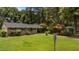 Lush, green front lawn with mature trees and landscaping framing this well-kept brick home at 625 Powell Dr, Rocky Mount, NC 27803