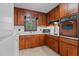 The warm kitchen features wood cabinetry and a suite of appliances at 625 Powell Dr, Rocky Mount, NC 27803