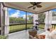 Bright screened porch with comfortable seating, ceiling fan, and scenic backyard view for relaxation and leisure at 71 Smithsanders Ct, Smithfield, NC 27577