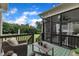 Inviting screened porch with wicker furniture and a view of the backyard for relaxing and outdoor living at 71 Smithsanders Ct, Smithfield, NC 27577