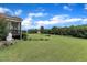 Expansive backyard featuring a lush lawn, mature trees, and established landscaping and screened porch at 71 Smithsanders Ct, Smithfield, NC 27577