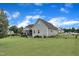 Well-maintained backyard featuring lush green grass, a gray home exterior, and a classic fence for added charm at 71 Smithsanders Ct, Smithfield, NC 27577