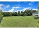 Expansive backyard with lush green grass, mature trees, and a charming fence creating a serene outdoor space at 71 Smithsanders Ct, Smithfield, NC 27577