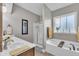 This bathroom features a bathtub, glass shower, and plenty of natural light at 71 Smithsanders Ct, Smithfield, NC 27577