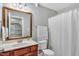 Well-lit bathroom featuring a vanity with a framed mirror and a shower with a white curtain at 71 Smithsanders Ct, Smithfield, NC 27577