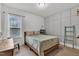 Bright bedroom featuring a full bed, gray accent wall with molding, and a large window at 71 Smithsanders Ct, Smithfield, NC 27577