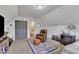 Attic bedroom with seating and dormer windows with leaf-patterned wall decorations at 71 Smithsanders Ct, Smithfield, NC 27577