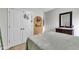 Bedroom with a closet, tan accent wall niche, wooden dresser, and gray patterned bedding at 71 Smithsanders Ct, Smithfield, NC 27577