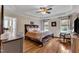 Bedroom with hardwood floors, ceiling fan, tray ceiling, and two windows with coverings at 71 Smithsanders Ct, Smithfield, NC 27577