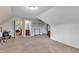Carpeted bonus room showing three doorways and neutral paint with white trim throughout at 71 Smithsanders Ct, Smithfield, NC 27577