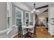 Bright dining area featuring hardwood floors, large windows, and modern chandelier lighting at 71 Smithsanders Ct, Smithfield, NC 27577