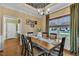 Dining room with hardwood floors, chandelier, and floral wallpapered tray ceiling detail at 71 Smithsanders Ct, Smithfield, NC 27577