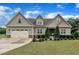 Charming craftsman home featuring a well-manicured lawn and an attached two-car garage at 71 Smithsanders Ct, Smithfield, NC 27577