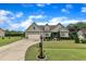Landscaped front yard with a view of a craftsman-style home and a lengthy driveway at 71 Smithsanders Ct, Smithfield, NC 27577
