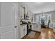 Well-lit kitchen featuring white cabinets, granite countertops, stainless steel appliances, and hardwood floors at 71 Smithsanders Ct, Smithfield, NC 27577