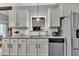 Updated kitchen features white cabinets, stainless appliances, granite countertops, and subway tile backsplash at 71 Smithsanders Ct, Smithfield, NC 27577