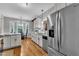 Eat-in kitchen features stainless refrigerator, white cabinets, granite counters, and a bay window dining nook at 71 Smithsanders Ct, Smithfield, NC 27577