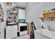 Well-organized laundry room featuring modern washer and dryer, ample shelving, and a utility sink at 71 Smithsanders Ct, Smithfield, NC 27577