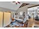 Open-concept living room with vaulted ceilings, hardwood floors, and a view into the kitchen and dining area at 71 Smithsanders Ct, Smithfield, NC 27577