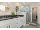 Elegant bathroom featuring double sinks, a glass-enclosed shower, and modern fixtures at 8004 Thrush Ridge Ln, Raleigh, NC 27615