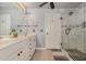 Bright bathroom featuring double vanity, granite counters, and luxurious marble shower at 8004 Thrush Ridge Ln, Raleigh, NC 27615