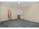 Spacious bedroom with carpet flooring and multiple entryways to other areas of the house at 8004 Thrush Ridge Ln, Raleigh, NC 27615