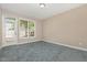 Inviting bedroom with a large window and door, filled with natural light and carpet flooring at 8004 Thrush Ridge Ln, Raleigh, NC 27615