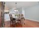 Bright dining room with hardwood floors, stylish table, and easy access to the kitchen and second floor at 8004 Thrush Ridge Ln, Raleigh, NC 27615